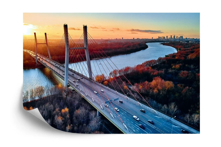 Fototapeta Beautiful Panoramic Aerial Drone View To Cable-Stayed Siekierkowski Bridge Over The Vistula River And Warsaw City Skyscrapers, Poland In Gold Red Autumn Colors In November Evening At Sunset